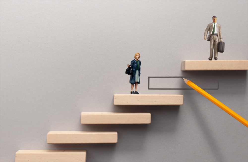 miniature,woman,and,man,standing,on,wooden,steps,on,different